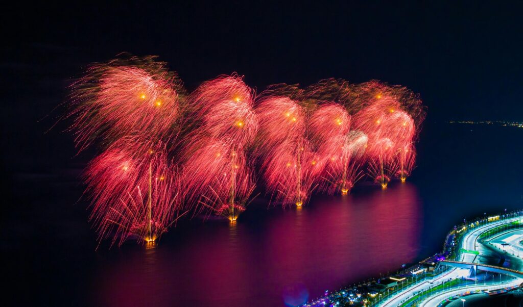 A stunning aerial view of a fireworks display over a river at night